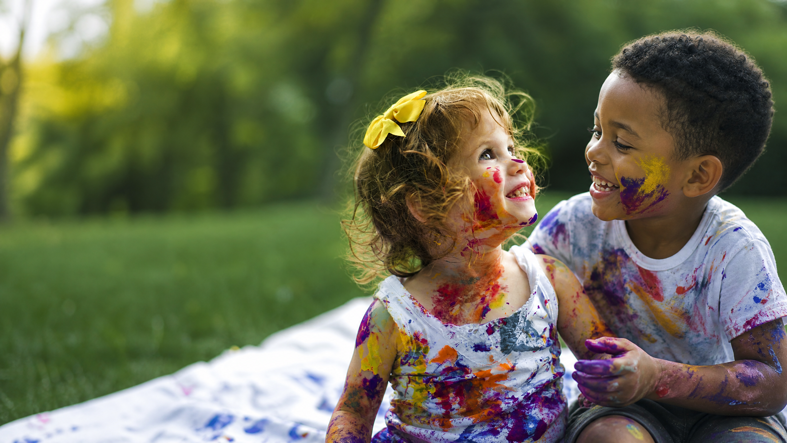 A child and caregiver sharing a calm moment together during an activity.